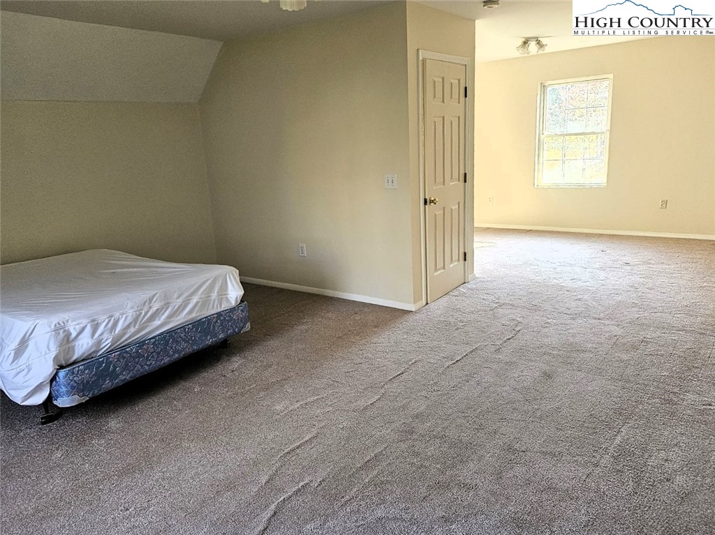 711 Trice Fork Mountain Road Newland, NC 28657 - Photo 10 of 22 a bedroom with a bed and a window