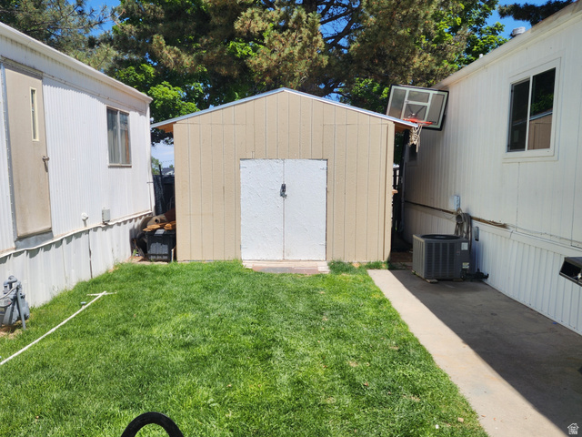 332 Joshua Street Tooele, UT 84074 - Photo 15 of 16 Detached shed with double doors, set between two structures