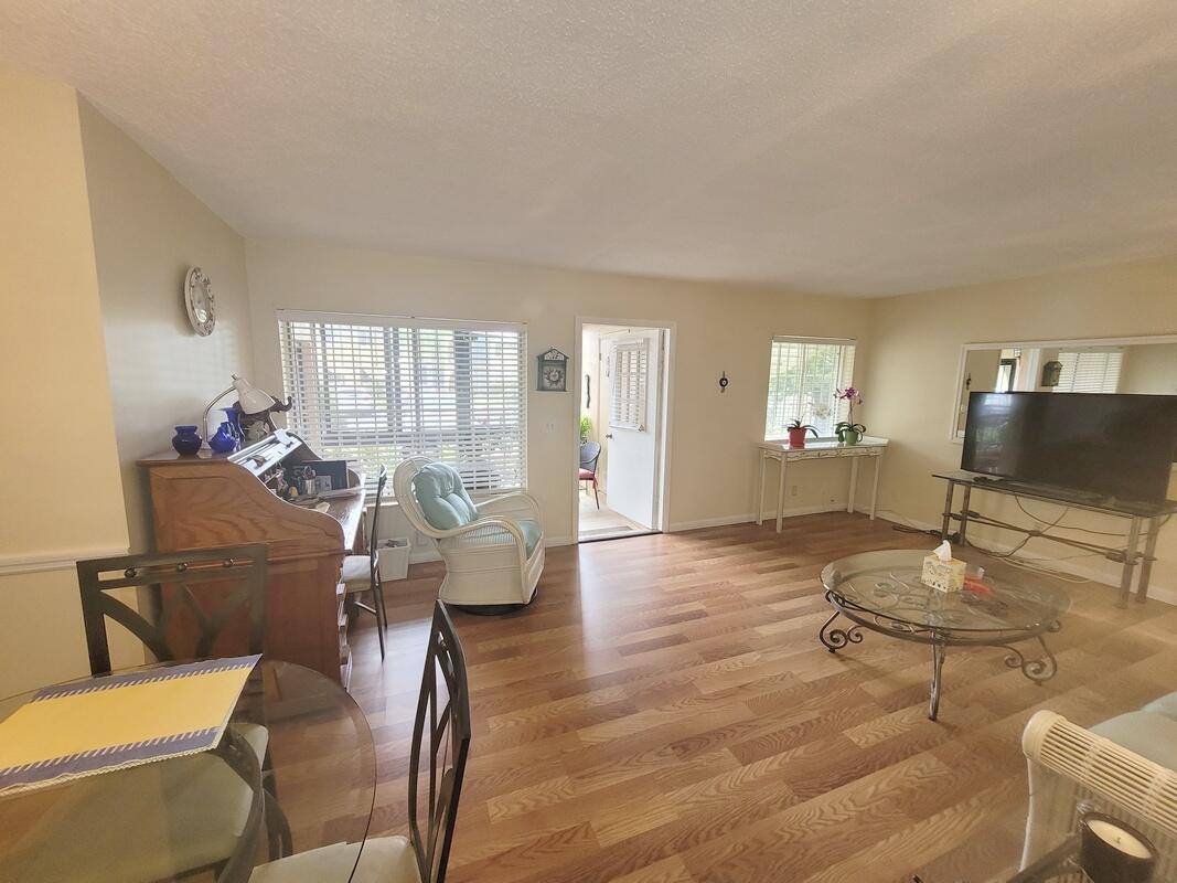 320 Pine Ridge Circle, Unit A1 Greenacres, FL 33463 - Photo 9 of 65 a living room with furniture and a table