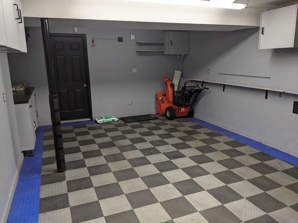 44 Boxford Road, Unit 44 Haverhill, MA 01835 - Photo 13 of 13 a view of a storage & utility room with a washing machine checkered tile floor