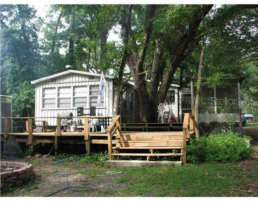 a view of a house with backyard sitting area and garden
