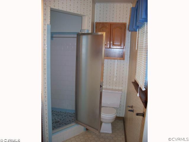 4700 Brookridge Road Chesterfield, VA 23832 - Photo 5 of 8 a bathroom with a granite countertop toilet and a shower