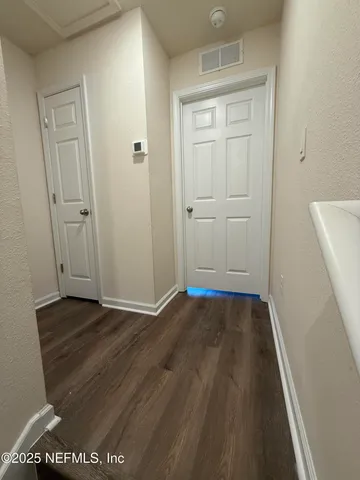 a view of an empty room and wooden floor