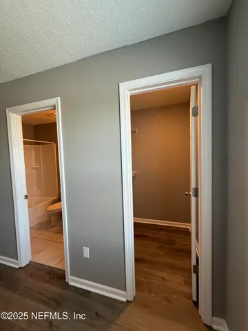 a view of a hallway with wooden floor