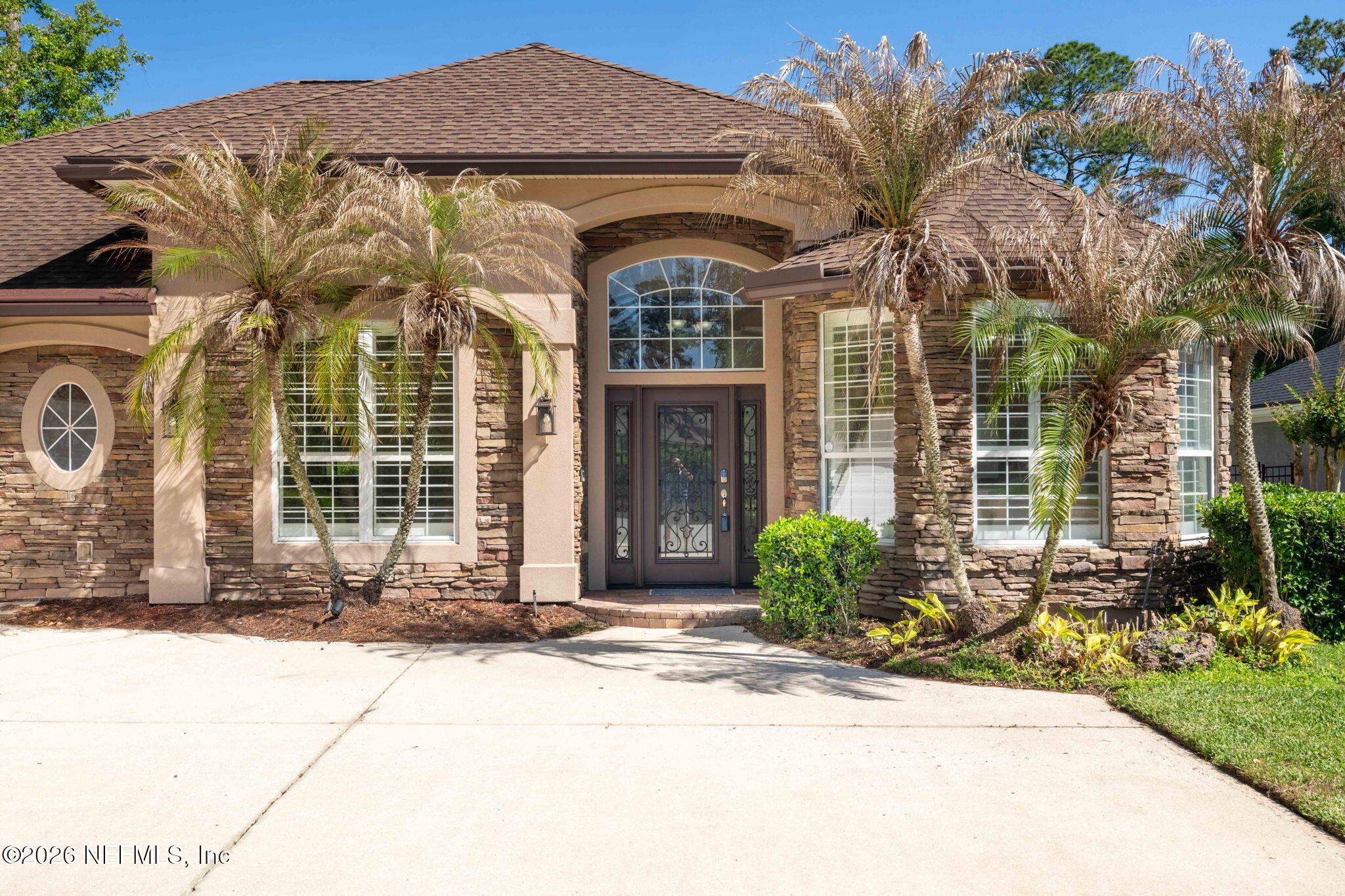 1600 Spring Water Court Fleming Island, FL 32003 - Photo 6 of 85 a front view of a house with a garden