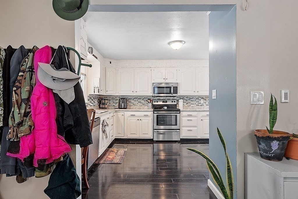 84 Euclid Street Gardner, MA 01440 - Photo 15 of 28 a kitchen with white cabinets and appliances