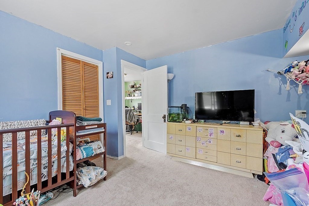 84 Euclid Street Gardner, MA 01440 - Photo 25 of 28 a bedroom with furniture and a flat screen tv