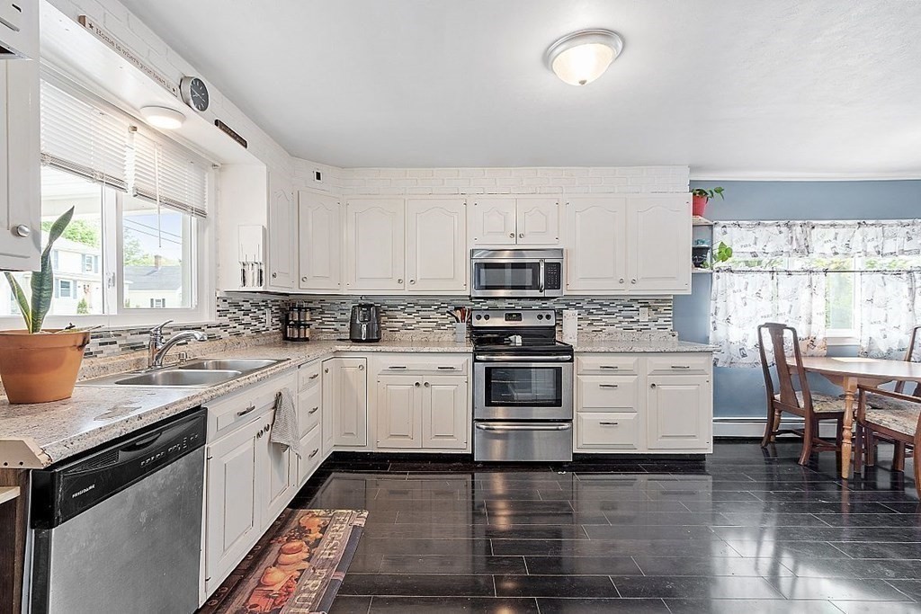 84 Euclid Street Gardner, MA 01440 - Photo 8 of 28 a kitchen with white cabinets and white appliances