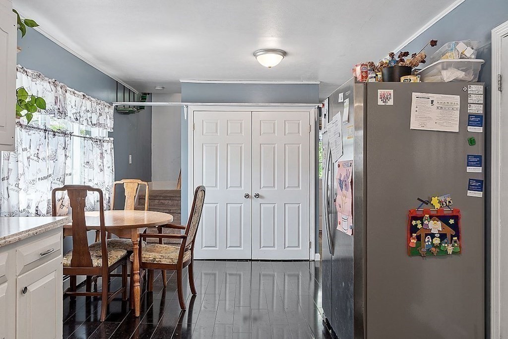 84 Euclid Street Gardner, MA 01440 - Photo 9 of 28 a view of a dining room with furniture a chandelier and wooden floor