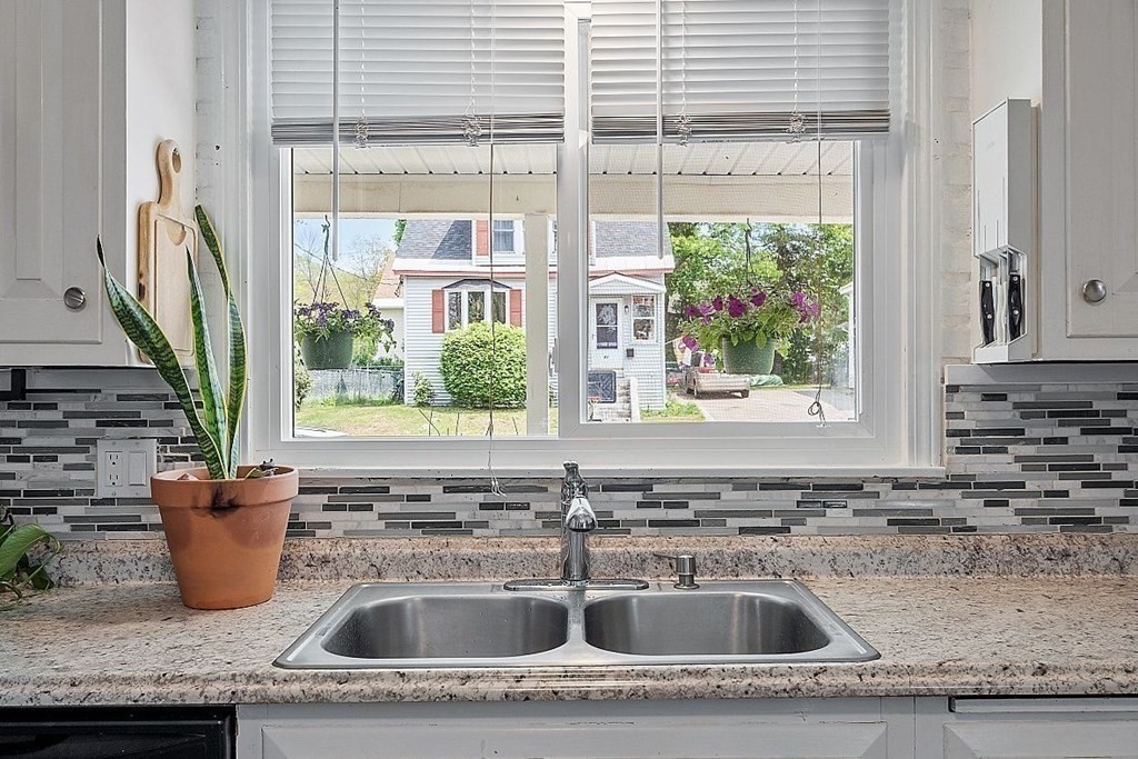 84 Euclid Street Gardner, MA 01440 - Photo 10 of 28 a kitchen with granite countertop a sink and a window