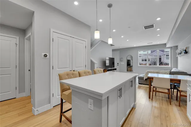 a large kitchen with a table and chairs
