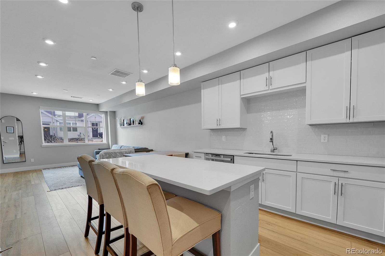 6211 West 28th Avenue Wheat Ridge, CO 80214 - Photo 14 of 29 a kitchen with a table chairs sink and cabinets