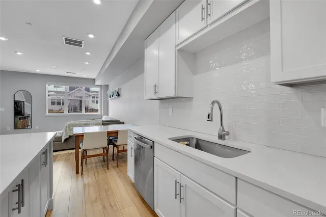 a kitchen with sink cabinets and wooden floor
