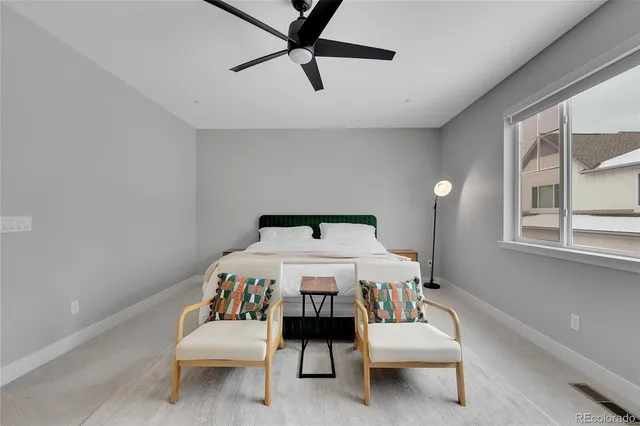 a bedroom with a bed a window and couch