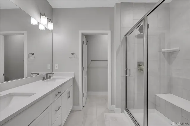a bathroom with a double vanity sink and mirror with shower