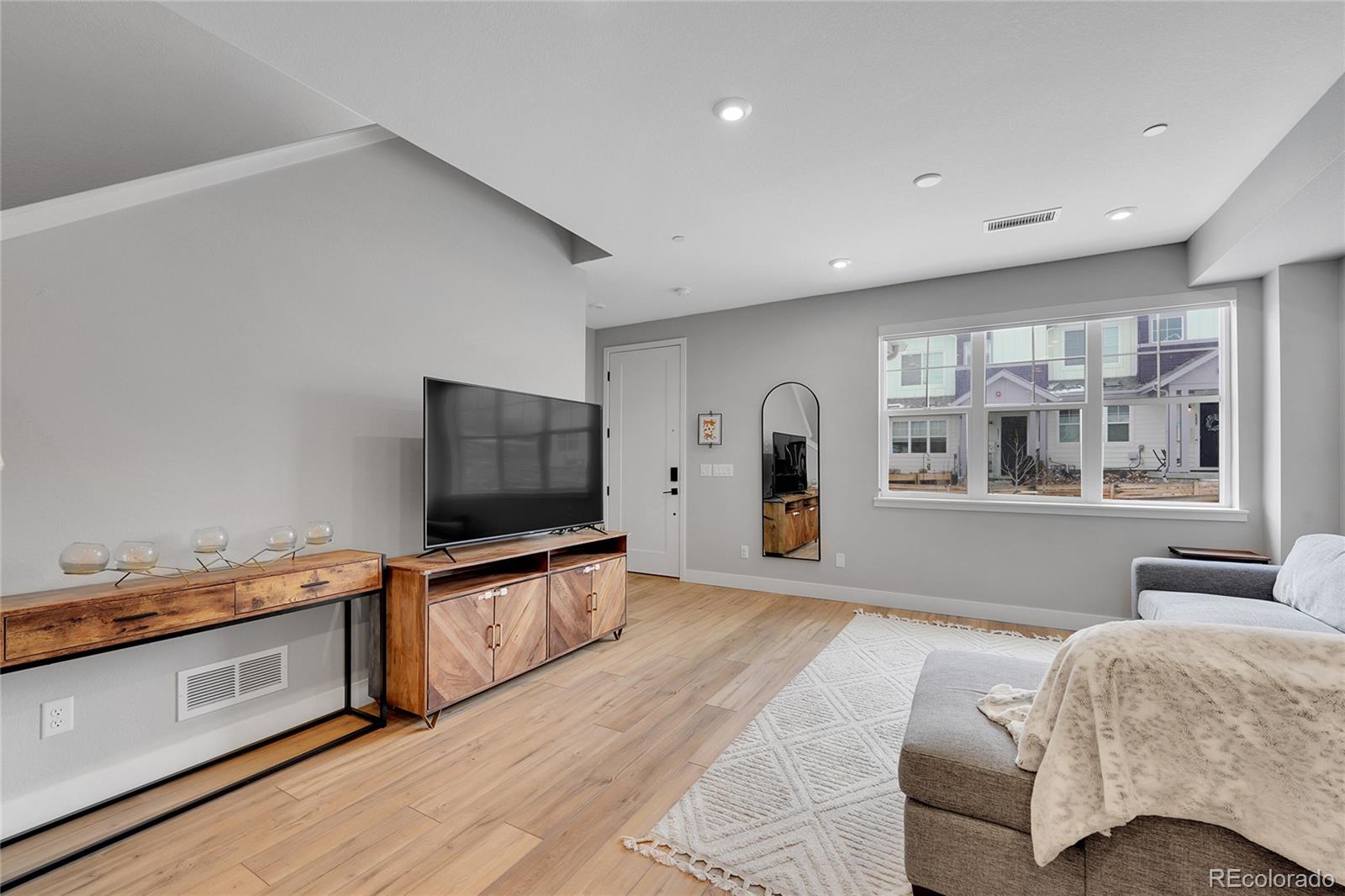 6211 West 28th Avenue Wheat Ridge, CO 80214 - Photo 5 of 29 a living room with furniture and a flat screen tv