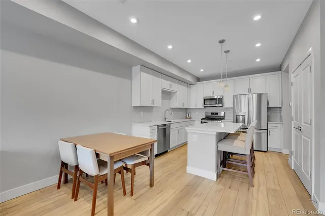 a view of kitchen with cabinets table and chairs