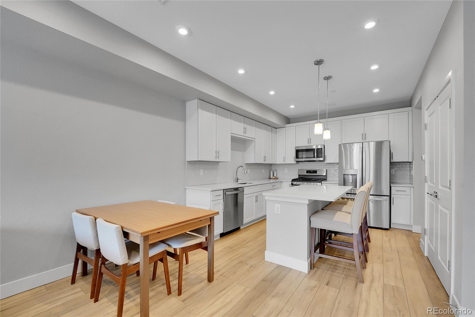 6211 West 28th Avenue Wheat Ridge, CO 80214 - Photo 10 of 29 a view of kitchen with cabinets table and chairs