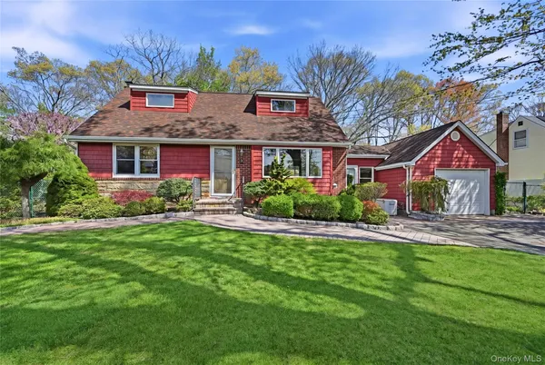 a front view of house with yard and green space