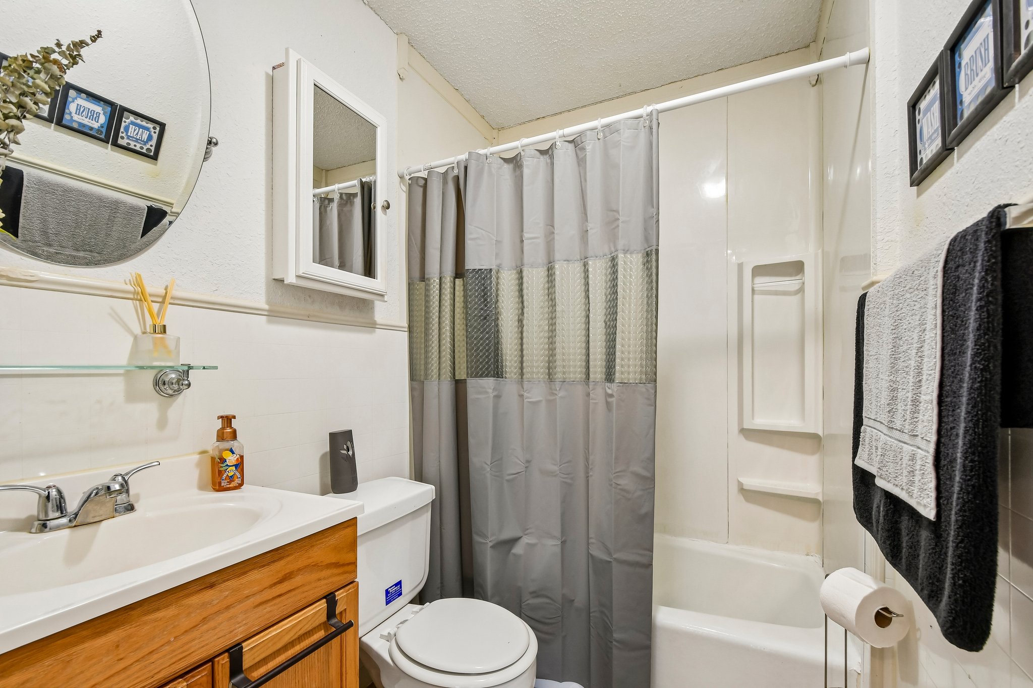 101 Brown Street Elgin, TX 78621 - Photo 22 of 32 a bathroom with a sink a toilet and shower a mirror