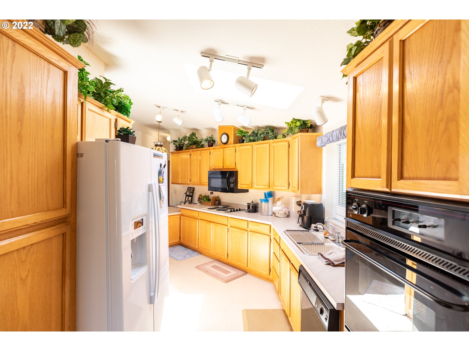 100 River Bend Road, Unit 116 Reedsport, OR 97467 - Photo 18 of 32 a kitchen with a refrigerator a stove and a microwave