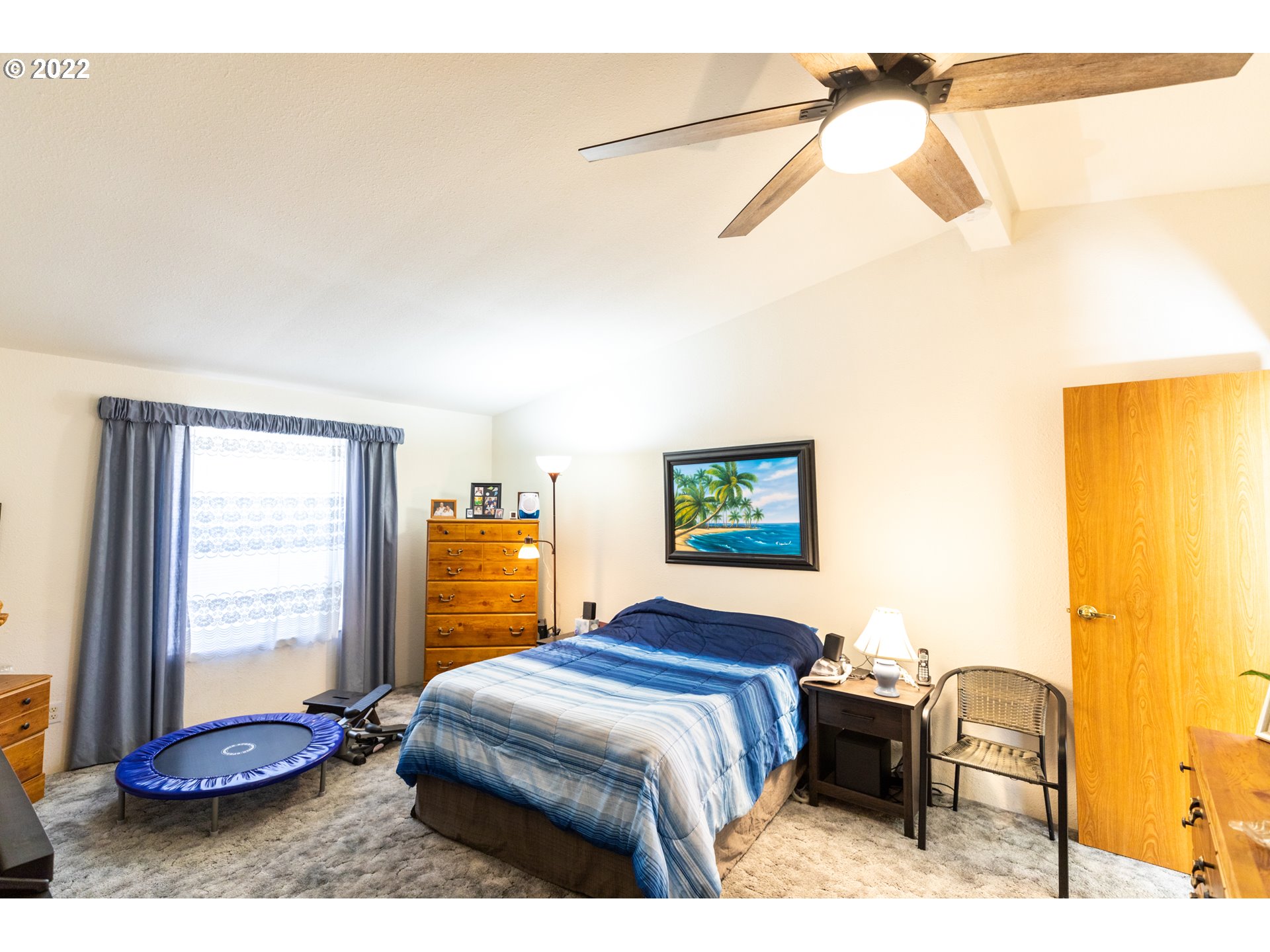 100 River Bend Road, Unit 116 Reedsport, OR 97467 - Photo 24 of 32 a bedroom with a bed and wooden floor