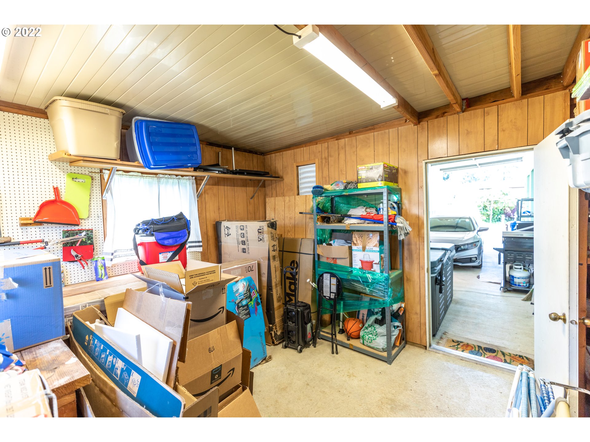 100 River Bend Road, Unit 116 Reedsport, OR 97467 - Photo 7 of 32 a garage filled with furniture and a chandelier
