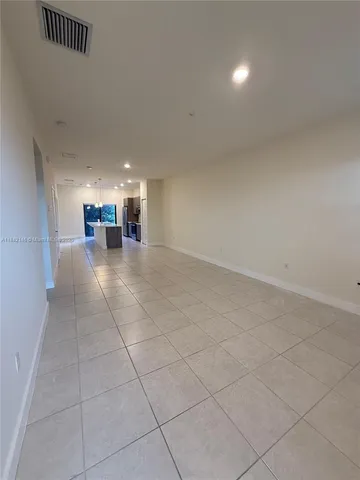 a view of a livingroom with furniture and an empty room