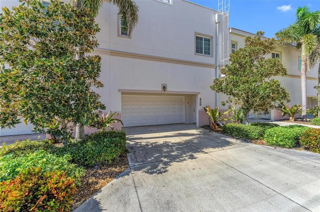a front view of a house with a yard and a garage
