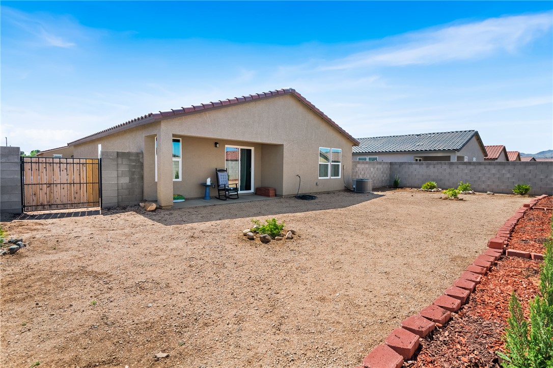 3623 East Andrea Drive Kingman, AZ 86409 - Photo 38 of 40 The property features a spacious rear yard with a covered patio, a privacy wall, and a side access gate