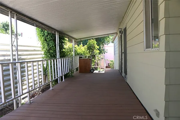 a view of a porch with wooden floor and outdoor space