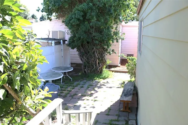 a view of a yard with chairs