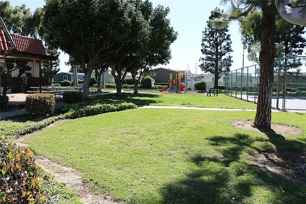 a view of a house with yard and swimming pool