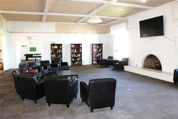 a room with pool table and windows