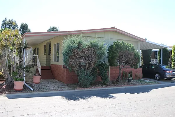 a view of a house with potted plants