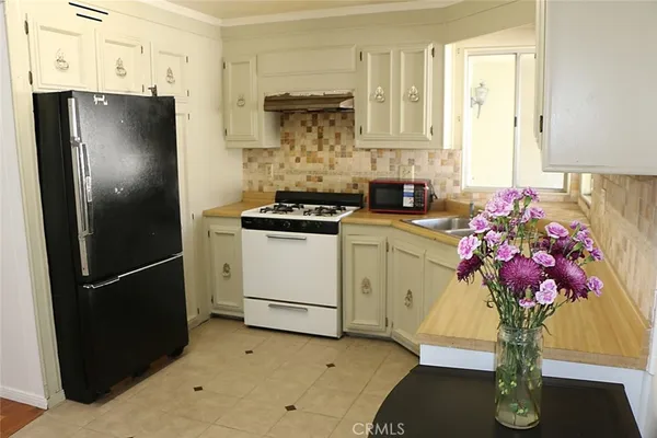a kitchen with a refrigerator and cabinets