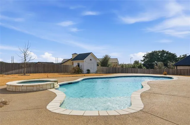 a view of a swimming pool and lounge chair