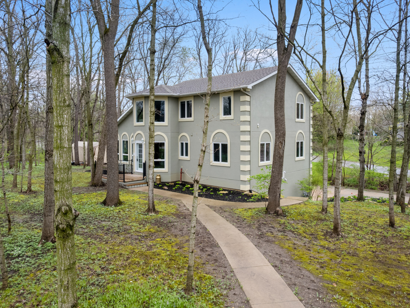a view of a white house with a yard patio and fire pit