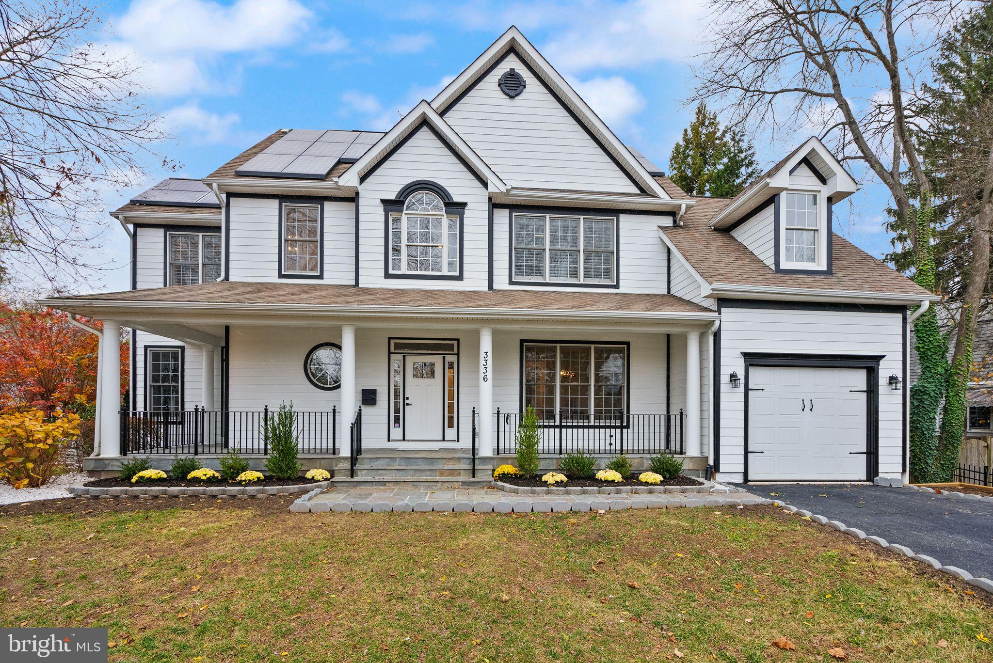 3336 Jones Bridge Court Chevy Chase, MD 20815 - Photo 3 of 99 a front view of a house with yard and parking