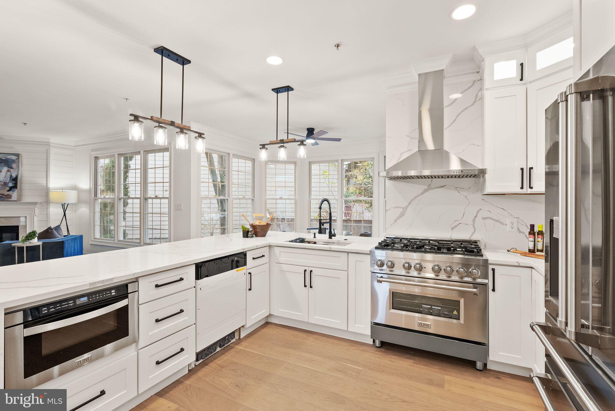 3336 Jones Bridge Court Chevy Chase, MD 20815 - Photo 32 of 99 a kitchen with stainless steel appliances a stove a sink and a wooden floor