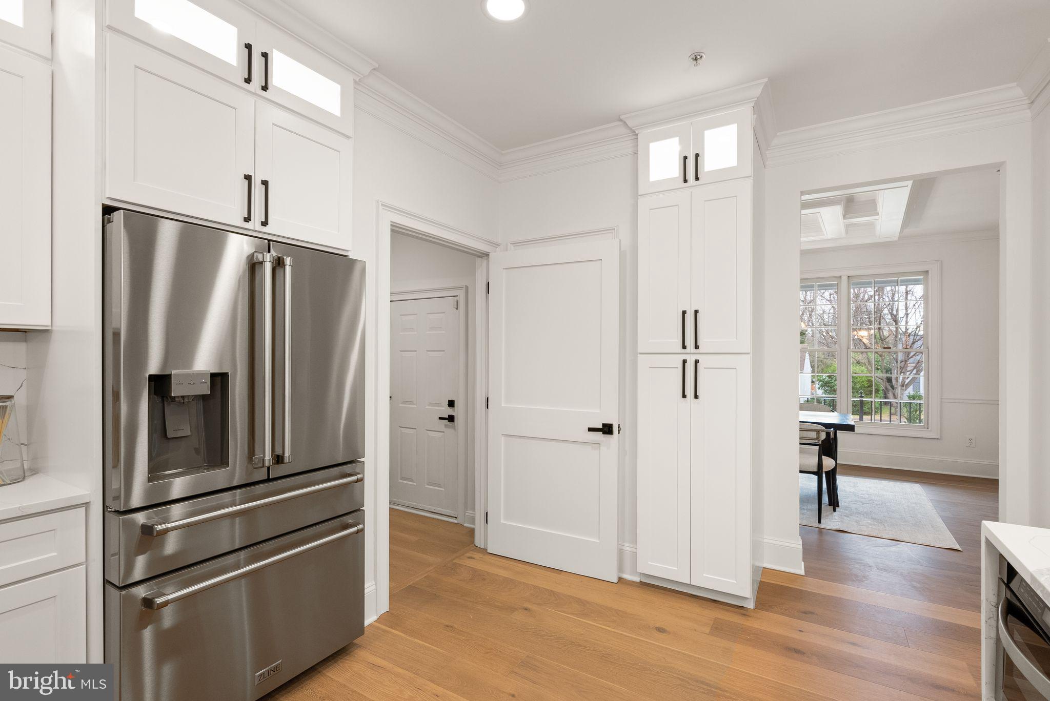 3336 Jones Bridge Court Chevy Chase, MD 20815 - Photo 37 of 99 a kitchen with stainless steel appliances a refrigerator and wooden floor