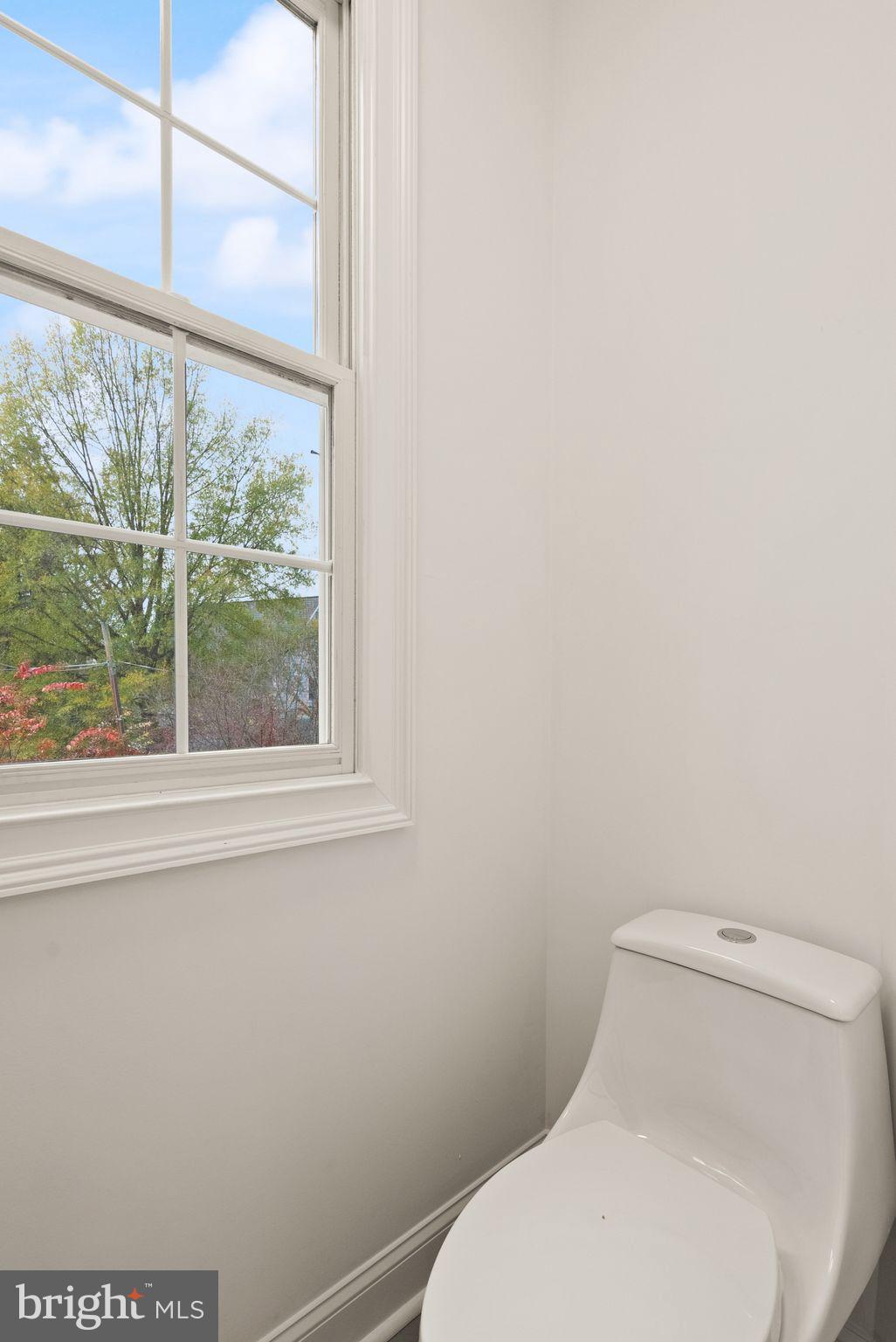 3336 Jones Bridge Court Chevy Chase, MD 20815 - Photo 59 of 99 a white toilet sitting next to a window