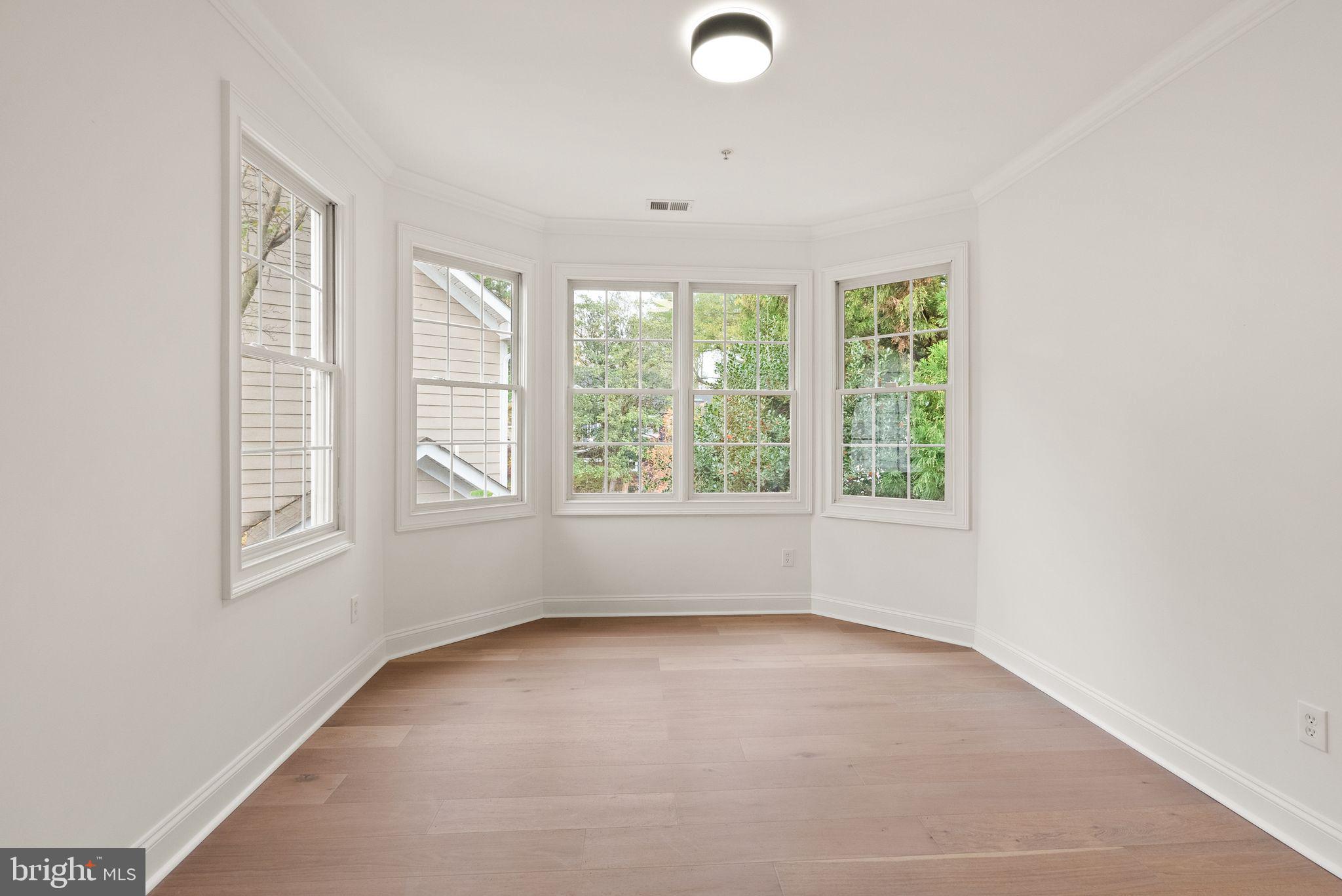 3336 Jones Bridge Court Chevy Chase, MD 20815 - Photo 60 of 99 an empty room with windows and yard