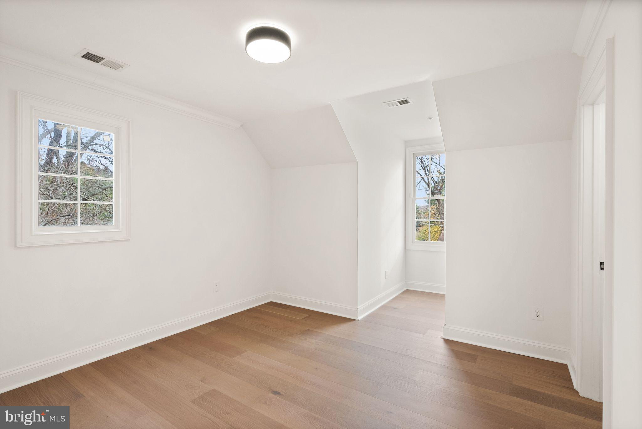 3336 Jones Bridge Court Chevy Chase, MD 20815 - Photo 73 of 99 an empty room with wooden floor and windows