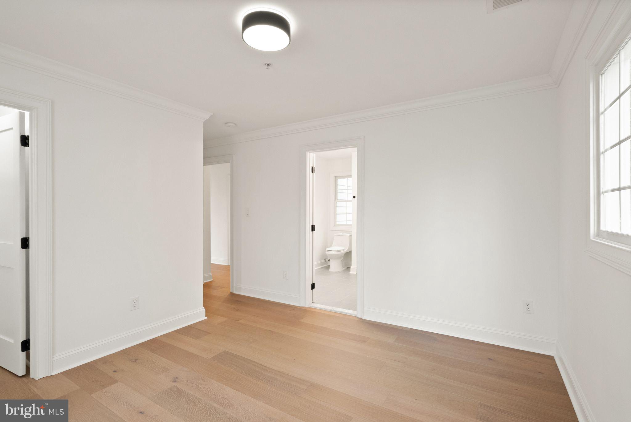 3336 Jones Bridge Court Chevy Chase, MD 20815 - Photo 75 of 99 an empty room with wooden floor and windows