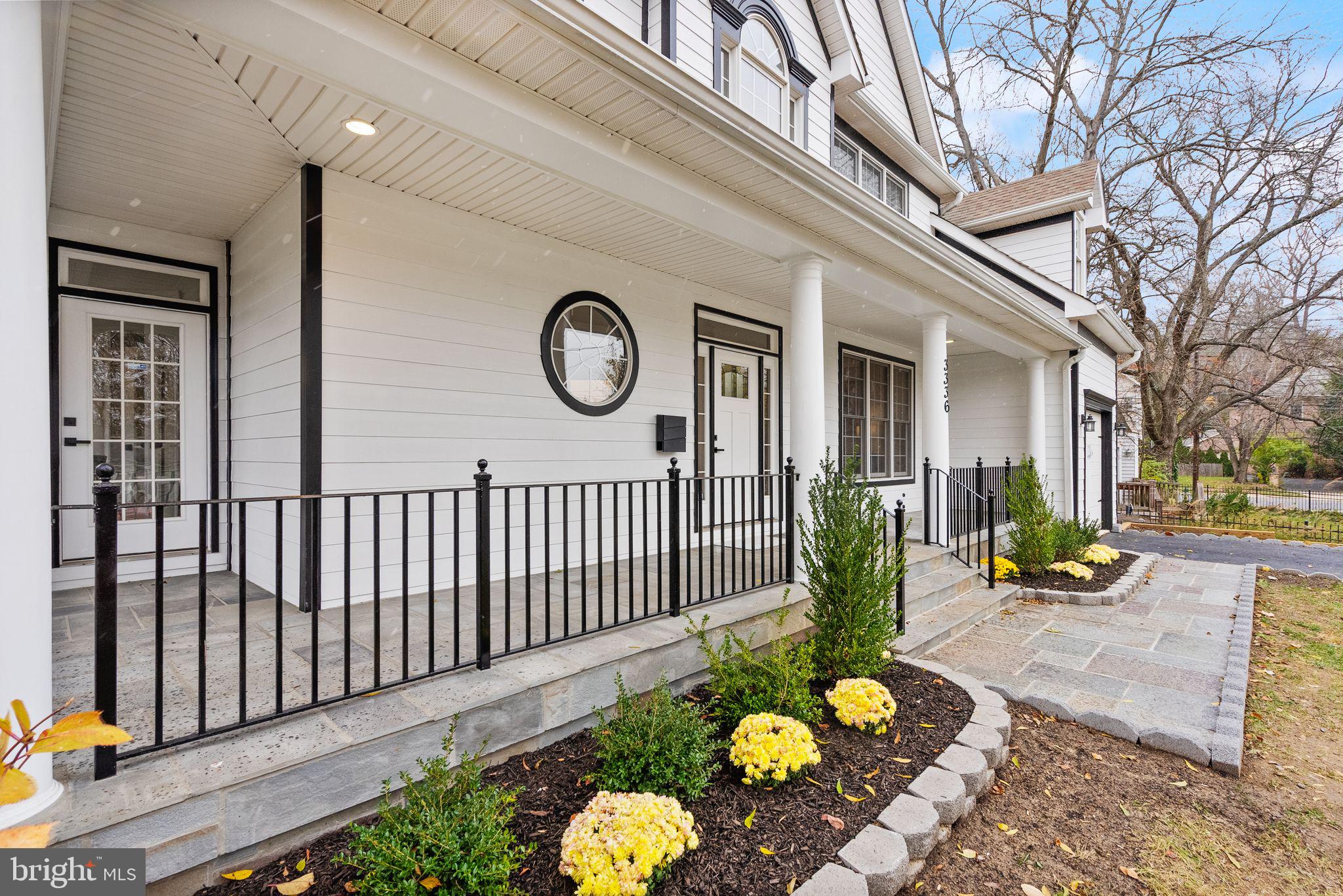 3336 Jones Bridge Court Chevy Chase, MD 20815 - Photo 8 of 99 a front view of a house with a garden and patio