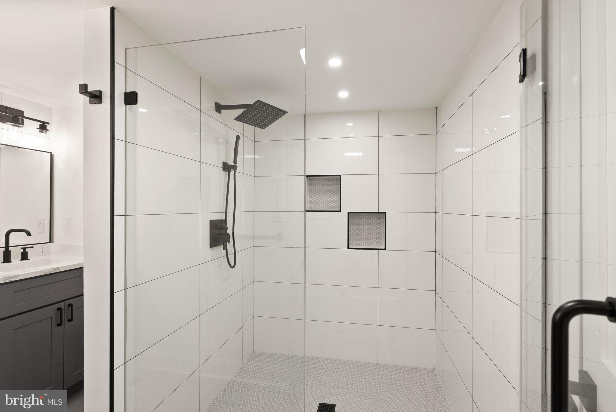 3336 Jones Bridge Court Chevy Chase, MD 20815 - Photo 92 of 99 a bathroom with a shower and a mirror