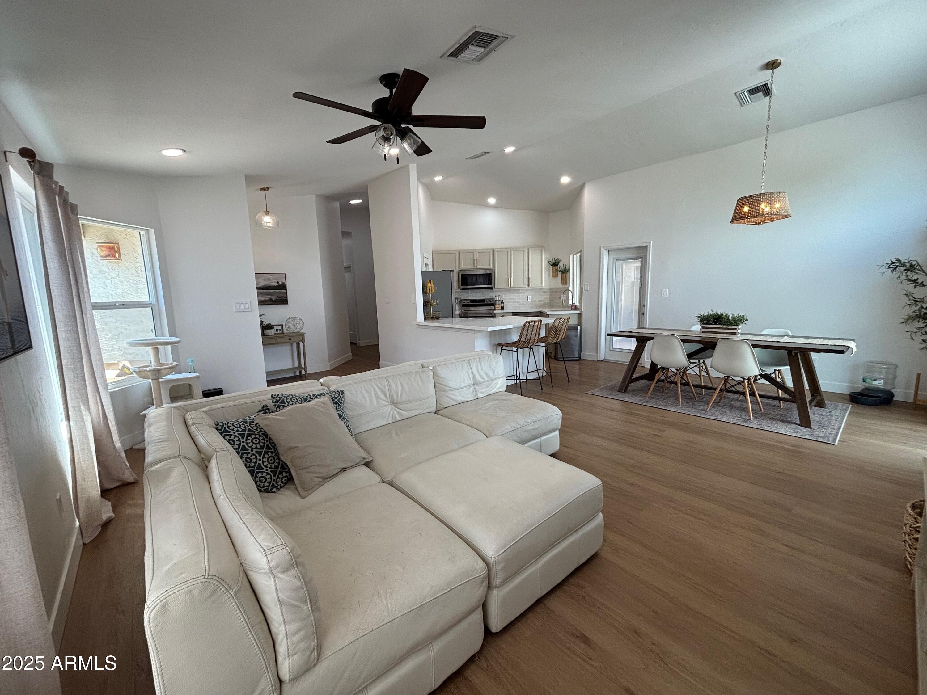 4725 East Brown Road, Unit 57 Mesa, AZ 85205 - Photo 1 of 14 a living room with furniture and a chandelier