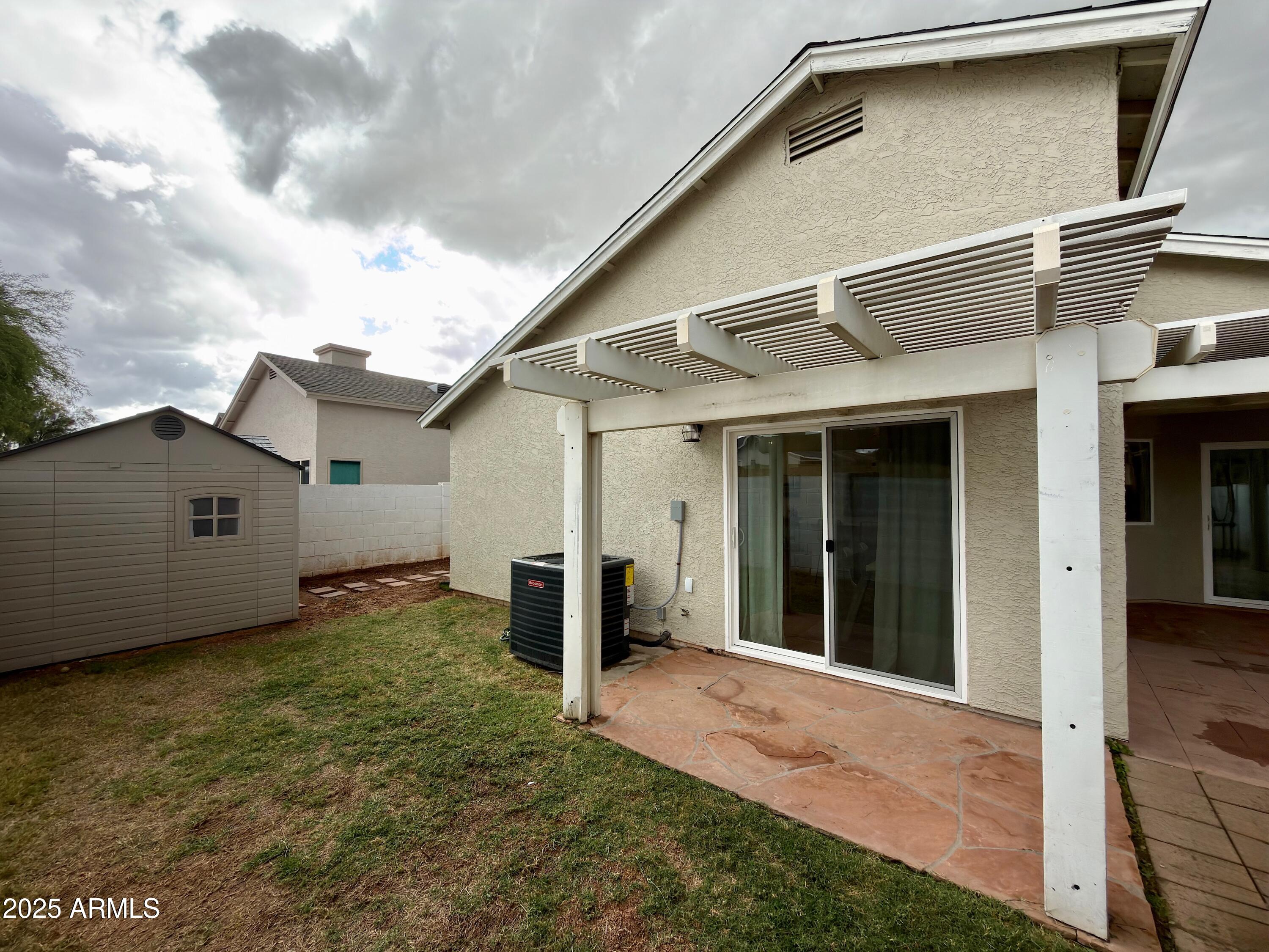 4725 East Brown Road, Unit 57 Mesa, AZ 85205 - Photo 11 of 14 a view of a house with backyard