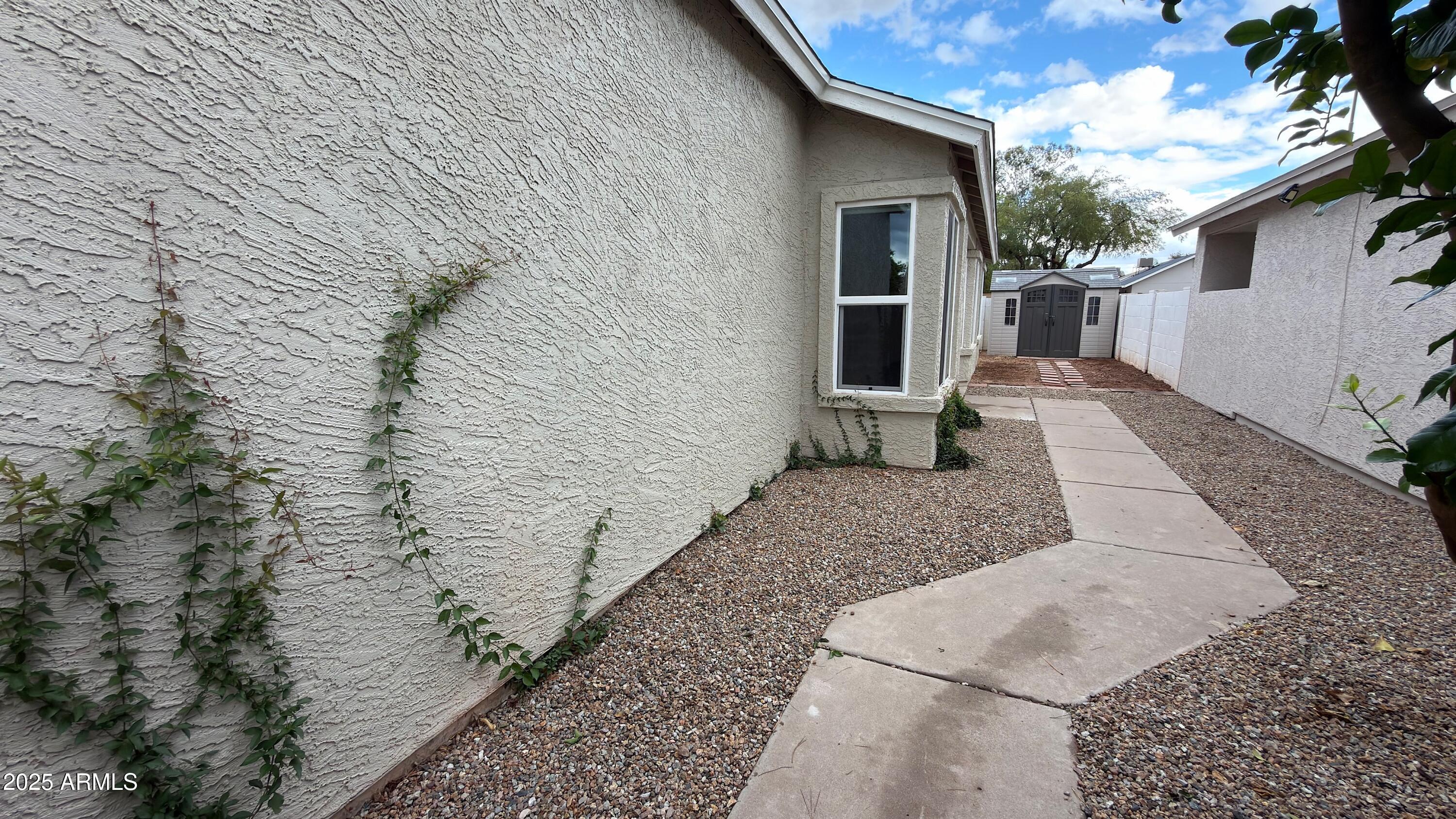 4725 East Brown Road, Unit 57 Mesa, AZ 85205 - Photo 12 of 14 a view of a patio with wooden wall